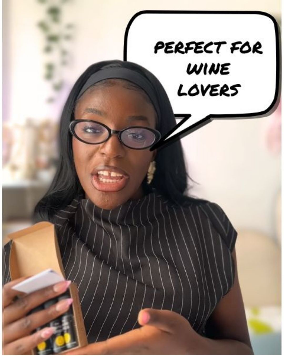 Woman holding The Wine Drops with a speech bubble saying 'Perfect for wine lovers' in an indoor setting.