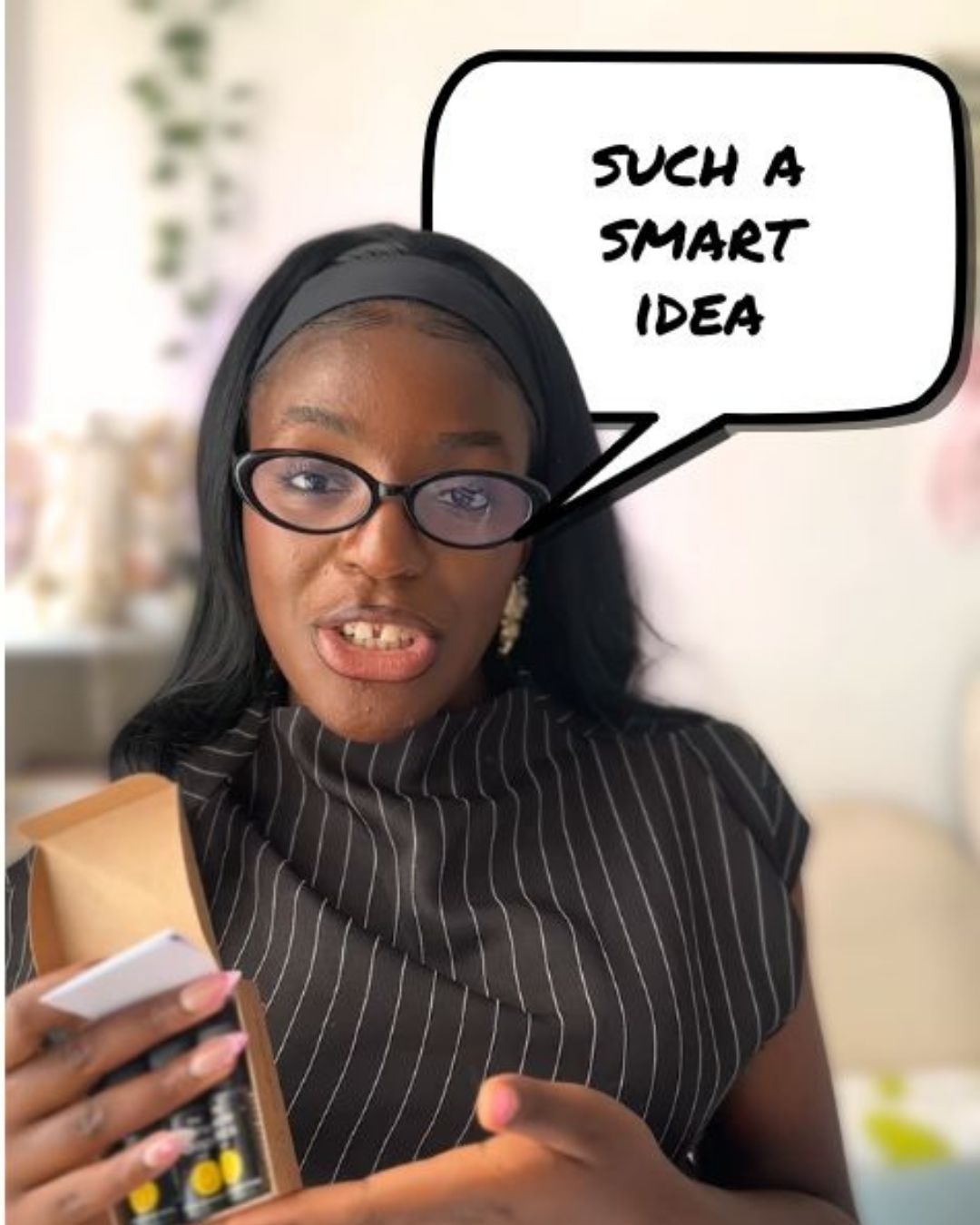 Woman holding The Wine Drops with a speech bubble saying 'Such a smart idea' in an indoor setting.